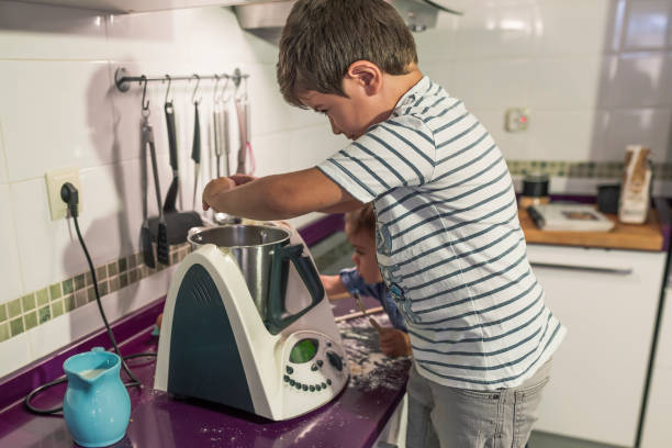 istock two children baking cake at home. 1277510841