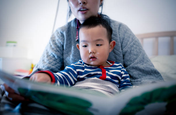 istock Mother with baby boy reading a picture book before sleeping 1277511701