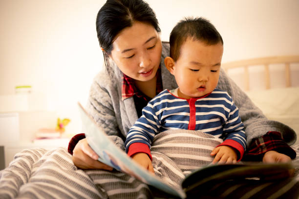 istock Mother reading story to her baby before sleeping 1277511967