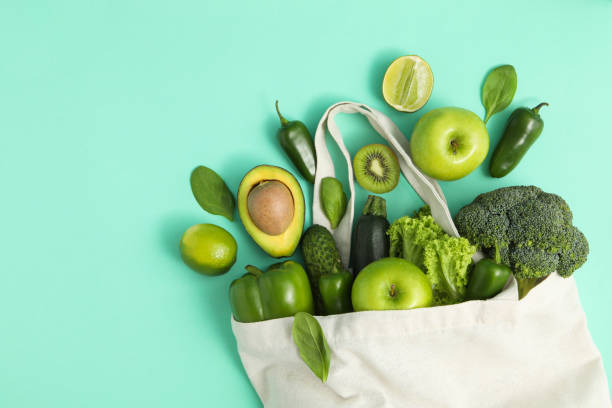 istock Bag with vegetables and fruits on mint background 1277513000