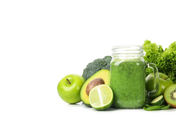 istock Green vegetables, fruits and jar of smoothie isolated on white background 1277513708