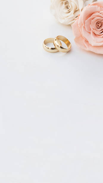 istock Golden wedding rings and two roses 1277513964