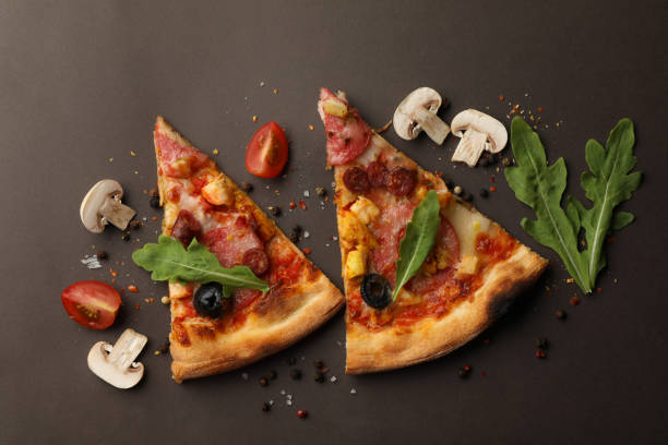 istock Pizza slices and ingredients on dark background 1277514391