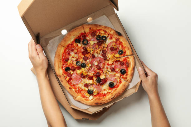 istock Female hand cut cheese pizza on white background 1277515645