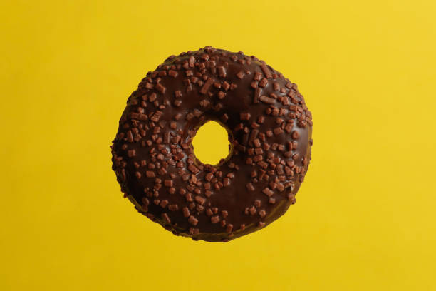 istock One tasty chocolate donut on yellow background 1277515843