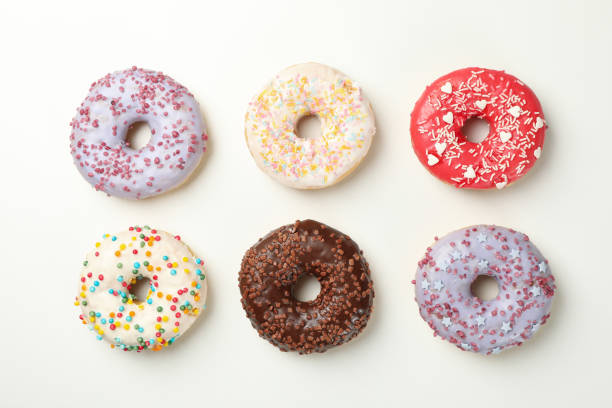 istock Flat lay with tasty donuts on white background 1277516628