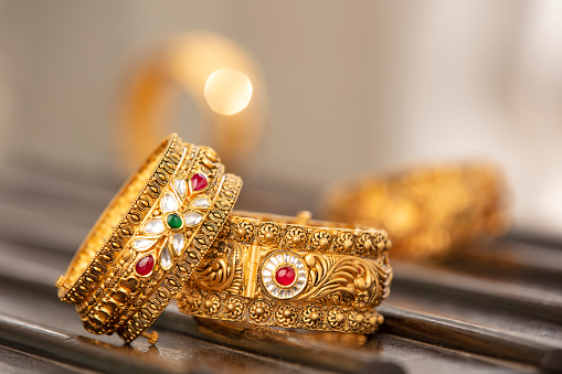 Fancy designer antique golden bracelets for woman fashion studio shot.