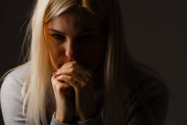 istock Religious girl praying on color background 1277517168