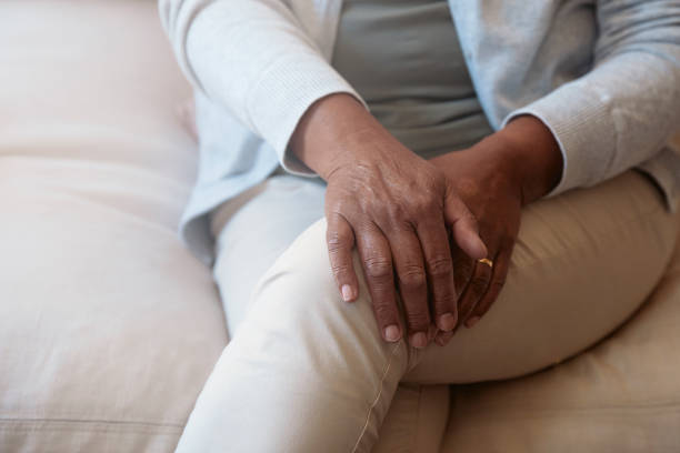 istock Senior woman sitting on sofa focus on hands 1277518842