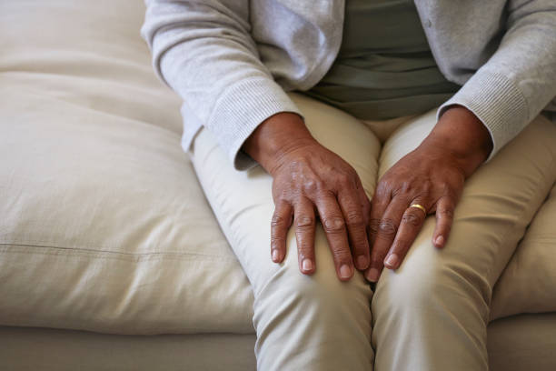 istock Senior woman sitting on sofa focus on hands 1277519036