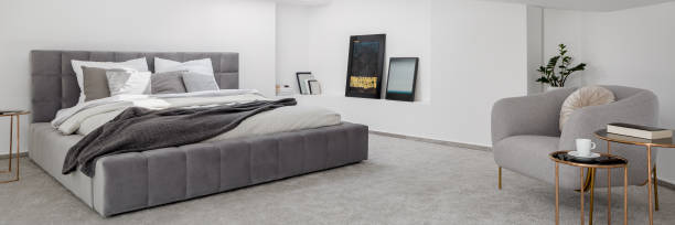 istock Panorama of bedroom with big, quilted bed 1277519714