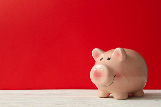 istock Piggy bank on red background, space for text 1277519785