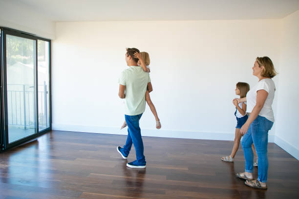 istock Side view of dad holding daughter and going to balcony 1277519831