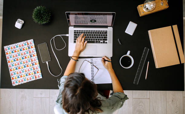 Multitasking young female entrepreneur at home office