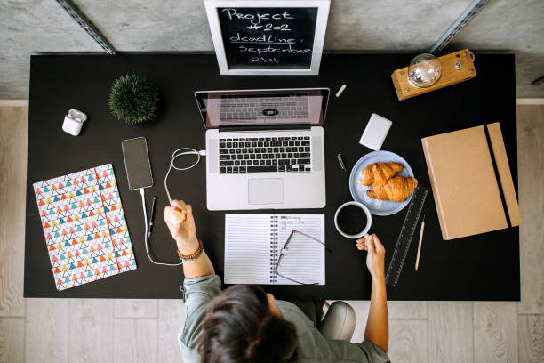 istock Businesswoman working at her office while having breakfast 1277520111