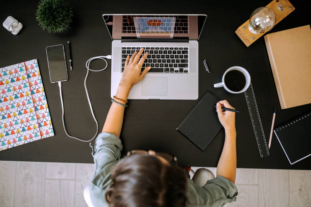 istock Young female graphic designer working on laptop in her home office 1277520130