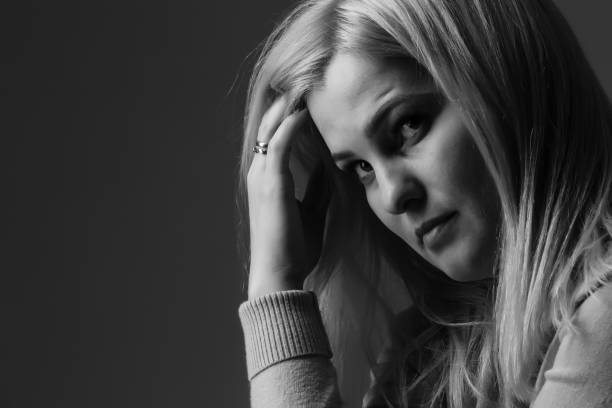 istock A young woman in prayer under dramatic light. 1277520286