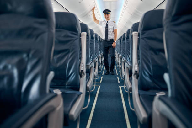 istock Dark blue colored passengers salon with man in uniform 1277521796