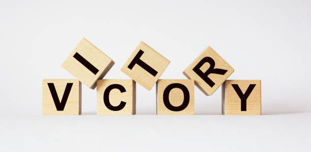 istock Victory, text on wooden cubes on light background 1277523502
