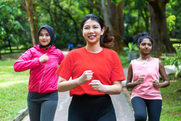 Group of multi ethnic women running in a public park