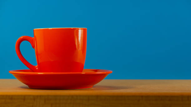 istock red cup with coffee on a plate stands on an oak table. 1277527920