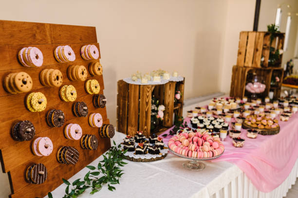 istock Candy bar. Table with different sweets for party. Wooden wedding decor. Different candies, cupcakes, souffle and cakes. Decorated in nature and eco theme, indoor. 1277528053