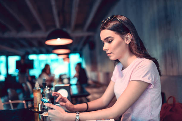 istock Female Beauty Typing On Smartphone In Restaurant 1277528134
