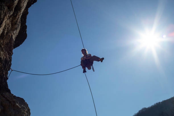 istock Woman lowering on the rope down the cliff 1277528174