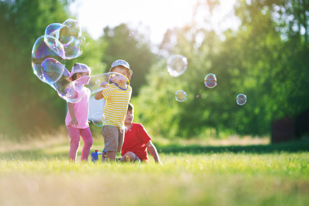 istock Happy children having fun in grass on sunny summer evening 1277528944