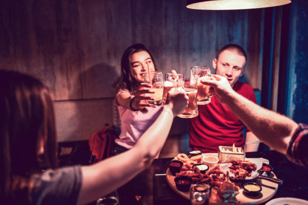 istock Celebratory Toast By Smiling Friends During Dinner Party 1277529178