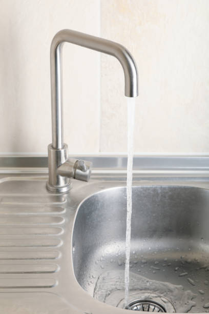 istock Water flowing from the tap in the kitchen sink 1277529261