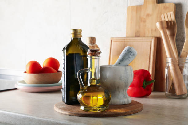 istock Kitchen table with different supplies and bottles with oil 1277530454