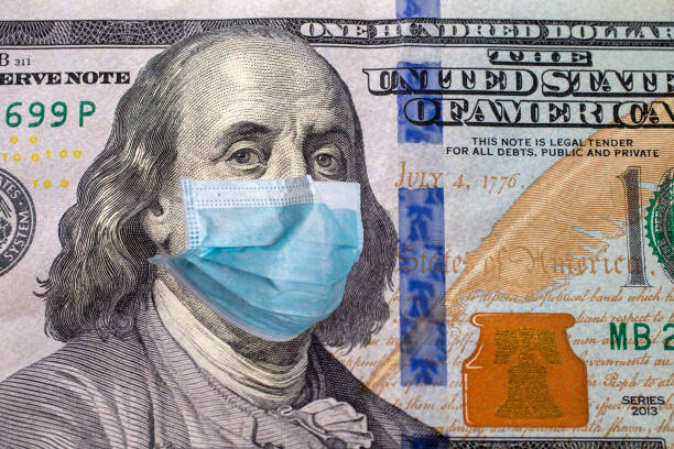 istock One hundred us dollars bill with face mask. Coronavirus covid outbreak concept 1277530485
