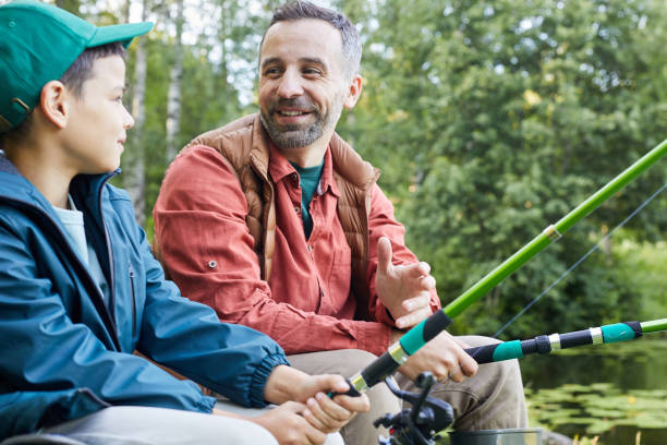 istock Happy Father Teaching Boy Fishing 1277531022