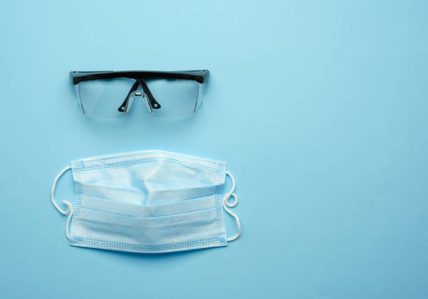 istock transparent plastic protective medical glasses and disposable mask 1277532088