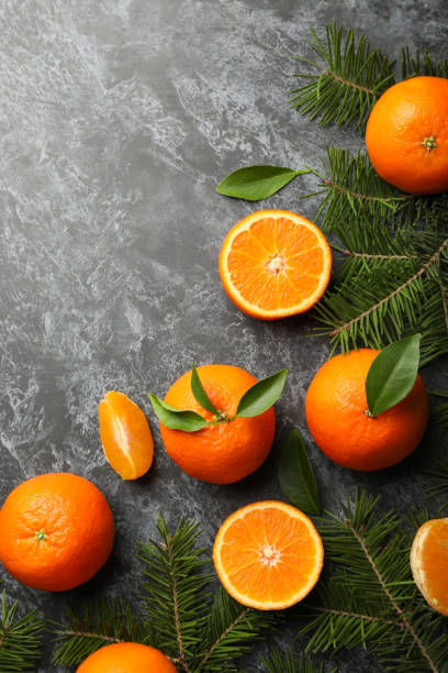 istock Mandarins and pine branches on gray smoky background 1277532261