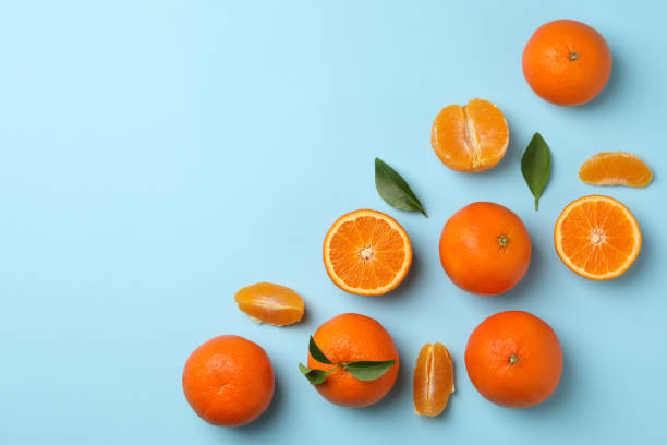 istock Ripe sweet mandarins on blue background, top view 1277532471