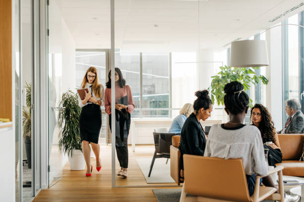 istock Diverse Business Associates Seated and Moving Through Office 1277533177