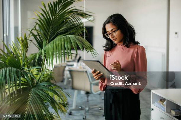 Young Indian Businesswoman Using Digital Tablet In Office Stock Photo - Download Image Now