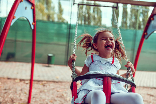istock Female Child Having Fun On Playground Swing 1277533541