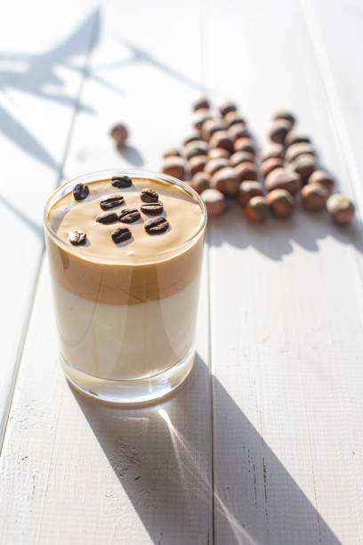 istock Traditional Korean caffeinated milk drink, Dalgona coffee in a transparent glass with coffee beans on a white board background. 1277533632