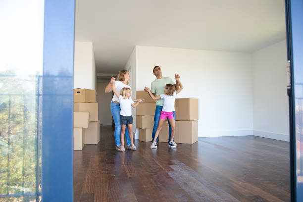istock Cheerful parents and daughters dancing and having fun 1277534972