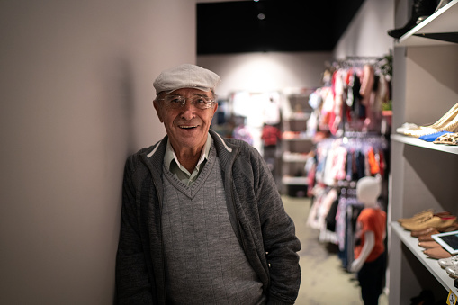 Portrait of a business senior owner man in a clothing store