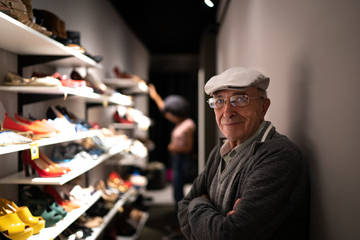 Portrait of a business senior owner man in a shoe store