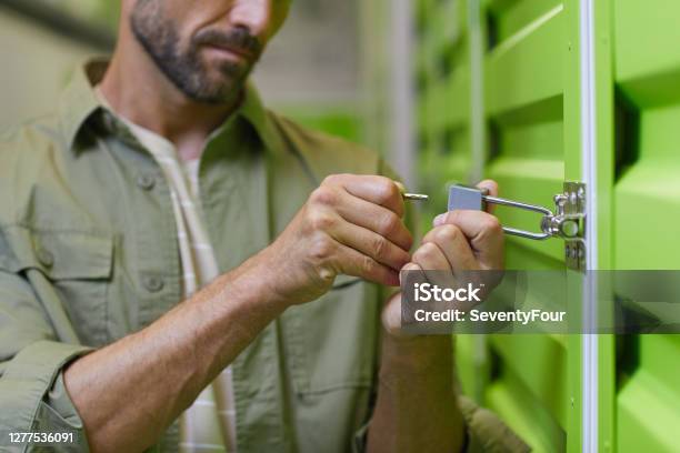 Man Opening Storage Unit Stock Photo - Download Image Now - Self Storage, Storage Compartment, Locking