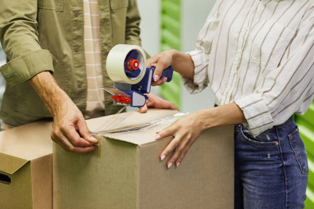 istock Couple Packing Boxes in Storage Unit Close Up 1277536123
