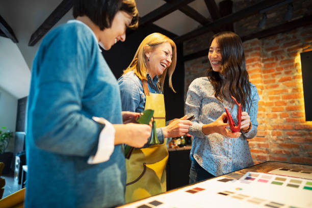 istock Smiling business owner with her two customers at the workshop 1277536499