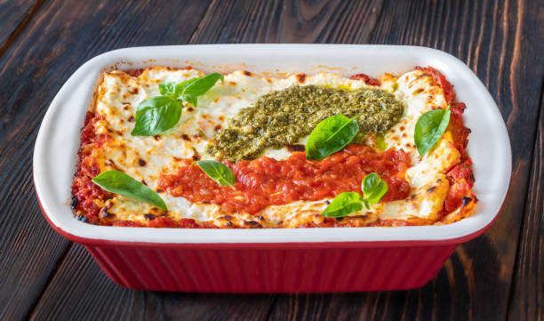 istock Lasagne topped with tomato sauce and pesto 1277537651