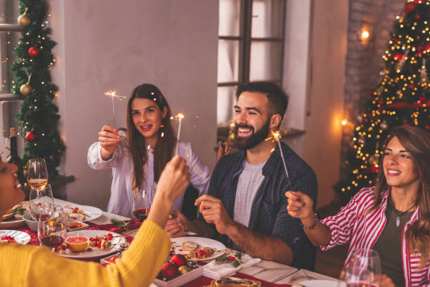 istock Friends waving with sparklers over Christmas dinner 1277538189