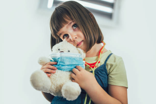 istock Child playing doctor with soft toy. 1277538537